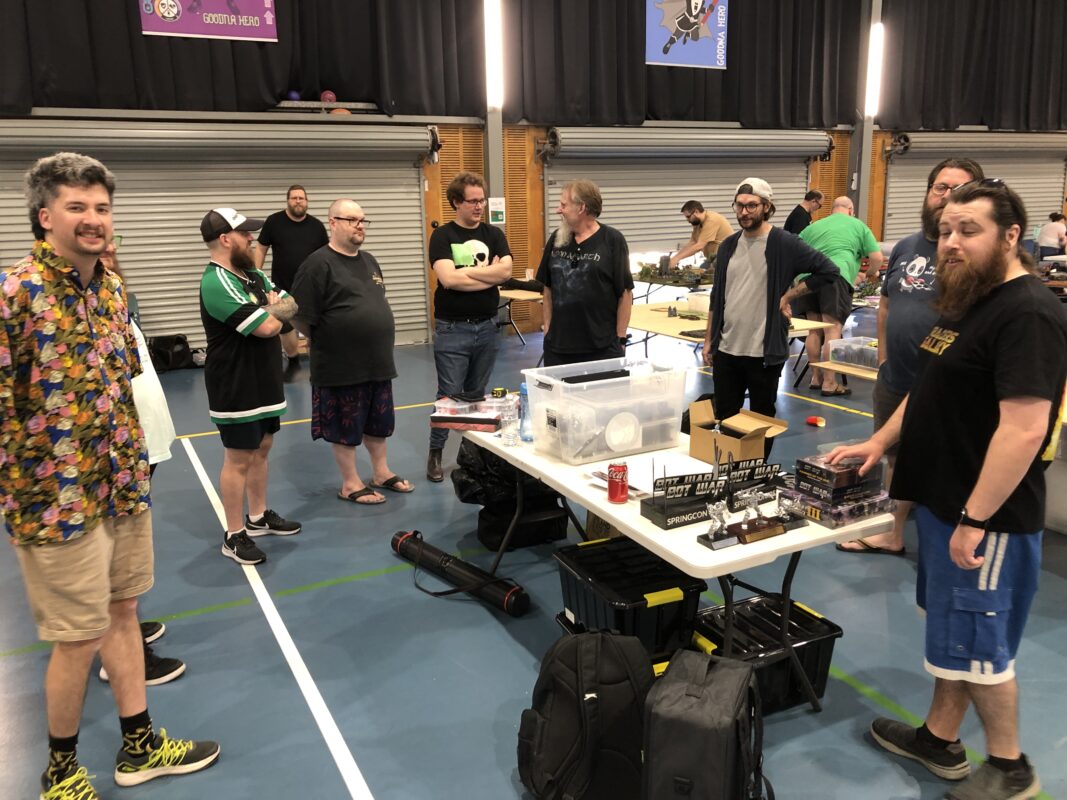Players gathered around a game at a convention