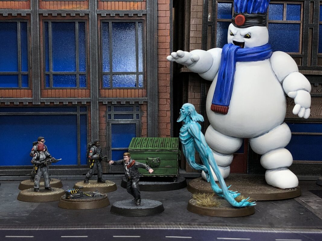 Monster hunters facing a giant marshmallow man and a ghost